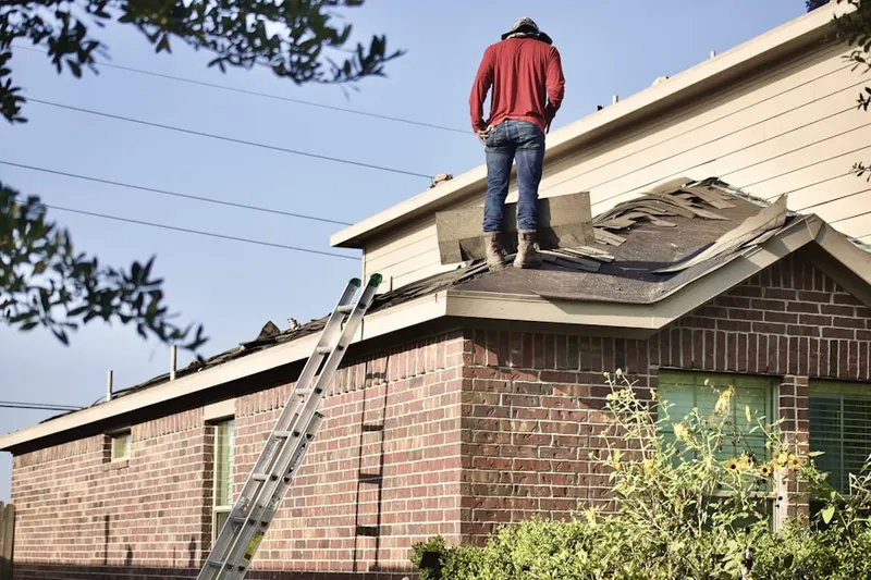 Professional roofer working on a residential roof in Wertz